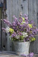 Mixed summer bouquet displayed in metal bucket - Ammi, Larkspur and Moluccella laevis