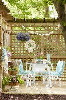 Vintage table and chairs in blue and white on trellised patio