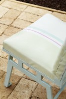 Vintage patio chair with painted striped upholstery