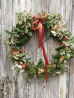 Completed Christmas wreath with fresh foliage and dried seed heads