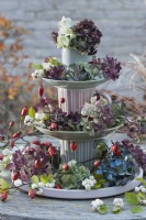 Etagere homemade from cups and plates, decorated with hydrangea blossoms and snowberries