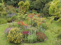 Colourful back garden with pond and island bed