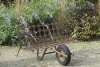 Fantasy bench made of corten steel and wheelbarrow.