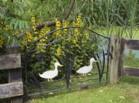 Ornamental garden gate with white painted ducks