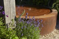 Circular water feature in The Vitamin G Garden at RHS Hampton Court Palace Garden Festival 2022 
