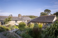 Cornish stone barn conversion house surrounded with a summer garden