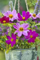 Bunch of flowers in pot containing monarda, dahlia, cosmos, agastache and fennel.