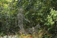 Wire man and dog sculpture by Tom Hill - Guide Dogs 90th Anniversary Garden, RHS Chelsea Flower Show 2021