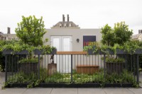 Balcony garden with plants in boxes trailing over railings =  Green Sky Pocket Garden, RHS Chelsea Flower Show 2021
