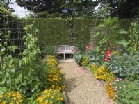Vegetable garden edged with marigolds and poppies