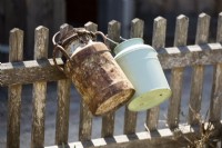 Milk cans on the garden fence, summer August