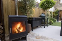 Log burner on contemporary patio area