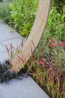 Planting of Ophiopogon and Imperata cylindrica 'Red Baron' grasses with Corten steel moongate detail - Sunburst Garden, RHS Hampton Court Palace Garden Festival 2022  