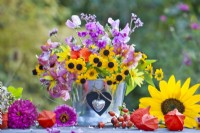 Floral arrangement with rudbeckia, sunflower and sweet peas.