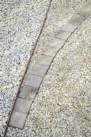 Detail of gravel path with wooden edging in A Journey, in Collaboration with Sue Ryder garden at RHS Hampton Court Palace Garden Festival 2022 - Designed by Katherine Holland