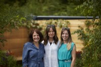 Emily Grayshaw, Imogen Perreau Callf and Judith Yeo. Garden Designers at Inspired Earth Design. Standing in their Gold Medal garden at RHS Hampton Court Garden Festival. 2022. Summer July.