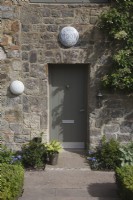 the front entrance of Full Moon Barn  with box edged pathway and light above the door