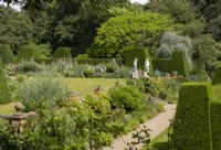  Herbaceous borders, statues and Taxus baccata topiary in the formal garden at Renishall Hall Gardens.