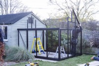 Man assembling greenhouse