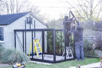 Men assembling greenhouse