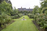 View of the house through the Rose Garden at The Burrows Gardens, Derbyshire, in August