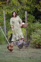 Garden owner, Susie Harris-Leblond walking with her pet chickens