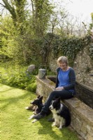 Woman with border collies in her garden 