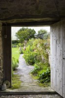 View into a country garden from a barn in April