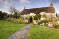 Thatched cottage in a country garden in April