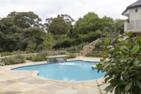View of pool terrace towards beds of mixed perennials