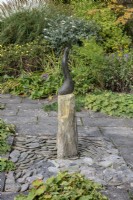 Resting on a plinth in the front garden, a bronze sculpture by  Vivien Whittaker.