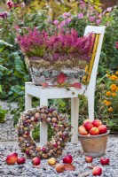 Bark container with heather, harvested apples and wreath.