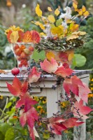 Autumnal arrangement with leaf wreath made from Boston ivy.
