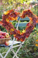 Heart shaped wreath made of maple  and persimmon leaves.