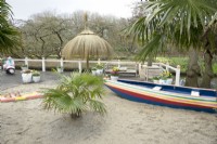 Inspiration Beach garden with boat and palm trees at Keukenhof.