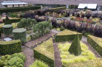 Aerial view of Whitburgh House Walled Garden in September including a sharply clipped pyramid of yew surrounded by Seslaria autumnalis.