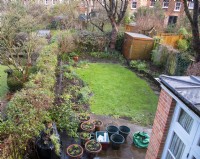 A 'Before' photo of a London garden awaiting a makeover.  Part of the remit was to replace the railroad sleepers and stone path around the raised bed with a brick wall and path and to extend the front and rear terraces.