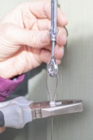 Woman crimping ferrules onto wire
