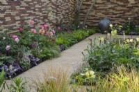 Border along  clay paver path with Paeonia 'Coral Sunset', Rose 'Queen of Sweden', Tiarella 'Pink Skyrocket' and Hakonechloa macra - The Stitcher's Garden, RHS Chelsea Flower Show 2022 - Silver Medal
