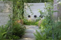 Purbeck stone steps up to shady seating area with oak bench and planting of Blechnum spicant and Valeriana alliariifolia - The Mind Garden - Gold Medal