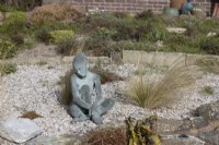 Marissa sculpture, in copper bronze by Jenny Wynne Jones sat amongst grasses and gravel. February. 