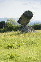 Stonebalancing sculpture by Adrian Gray in a Wiltshire garden in May