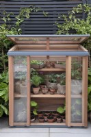 A cedarwood upright coldframe on the Gabriel Ash stand at RHS Chelsea Flower Show 2023