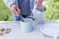 Woman mixing water with grout