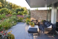 Outdoor seating area with a view over the mixed herbaceous border.