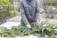 Woman trimming the pine branches