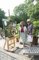 Owners Villa Sprezzatura showing the not yet finished oil painting of their garden on the roof terrace.