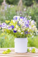 Bouquet of flowers containing Gypsophila elegans 'Covent Garden', Alchemilla mollis, Lathyrus 'Blue Ripple' and 'High Scent' and Briza maxima