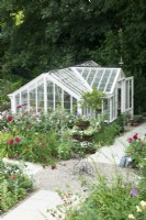 View of the Victorian greenhouse surrounded by roses from the roof terrace.