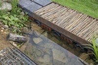 Recycled metal grille over the water feature in The Wildlife Trusts: Wilder Spaces garden at RHS Malvern Spring Festival 2023